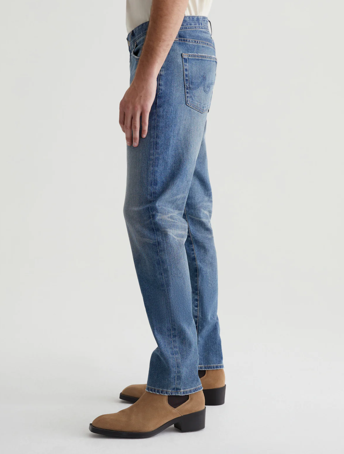 model wearing ag jeans tells modern slim jean in 16 years clifton blue, shown from the side