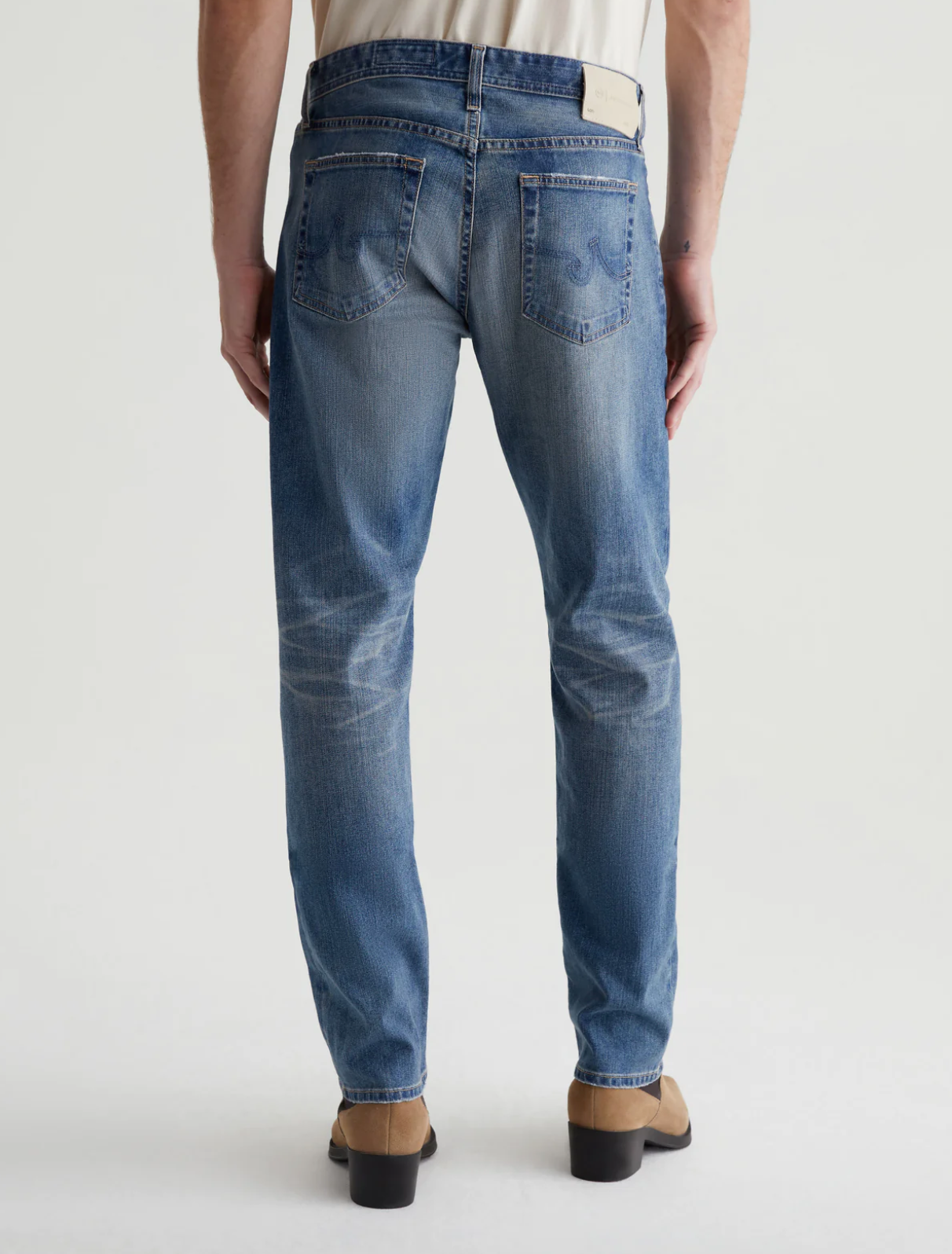 model wearing ag jeans tells modern slim jean in 16 years clifton blue, shown from the rear