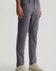 model wearing ag jeans tellis modern slim twill pants in folkestone grey, shown from the waist down