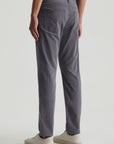 model wearing ag jeans tellis modern slim twill pants in folkestone grey, shown from the rear
