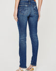 model wearing ag jeans prima mid rise slim jean in brighton blue, shown from the rear