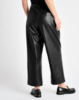 rear view of the black vegan leather ankle length wide leg trousers