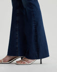 close up of the hem of ag jeans farrah boot cut in kindling blue, showing raw hem