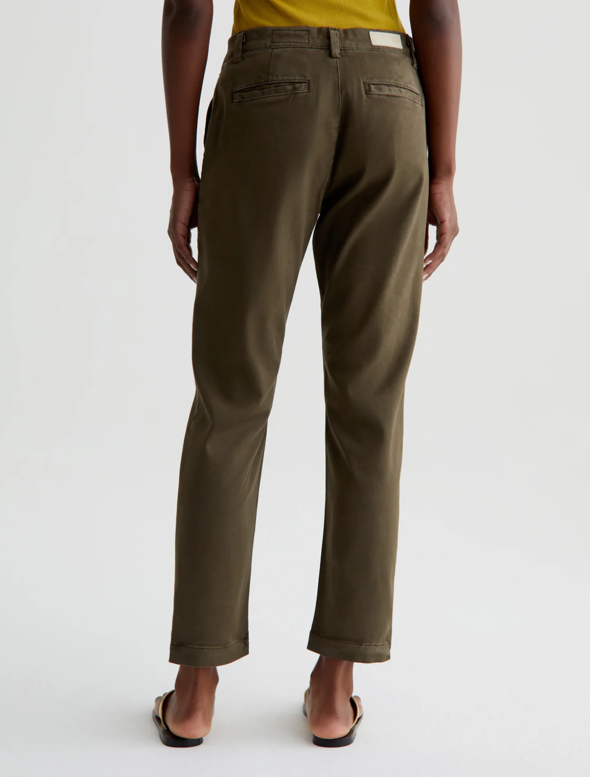 model wearing caden tailored trouser in sulfur shady moss green, shown from the rear
