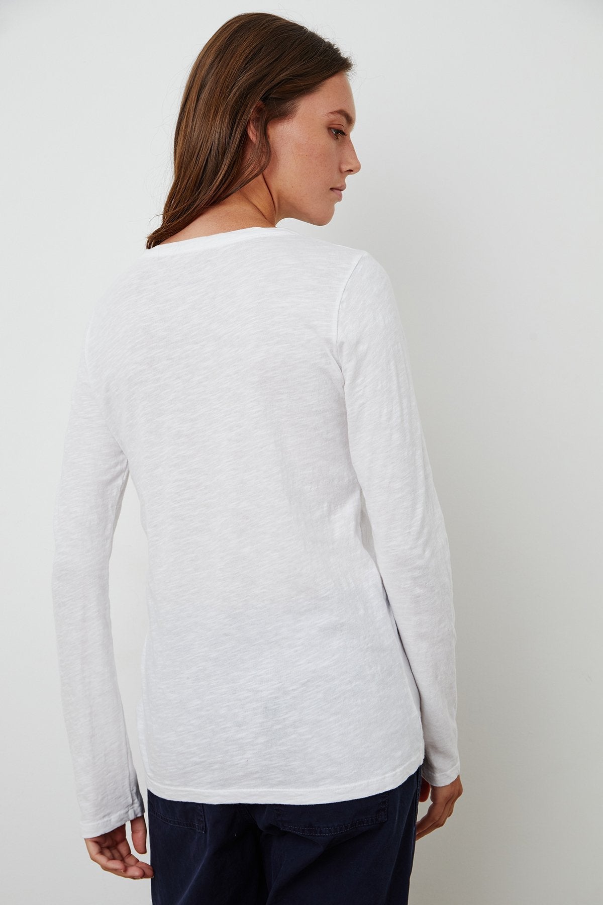 model wearing liz city slub crew neck long sleeve tee in white from Velvet, shown from the back