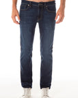 model wearing fidelity denim jimmy slim straight jean in empirical blue, shown from the waist down