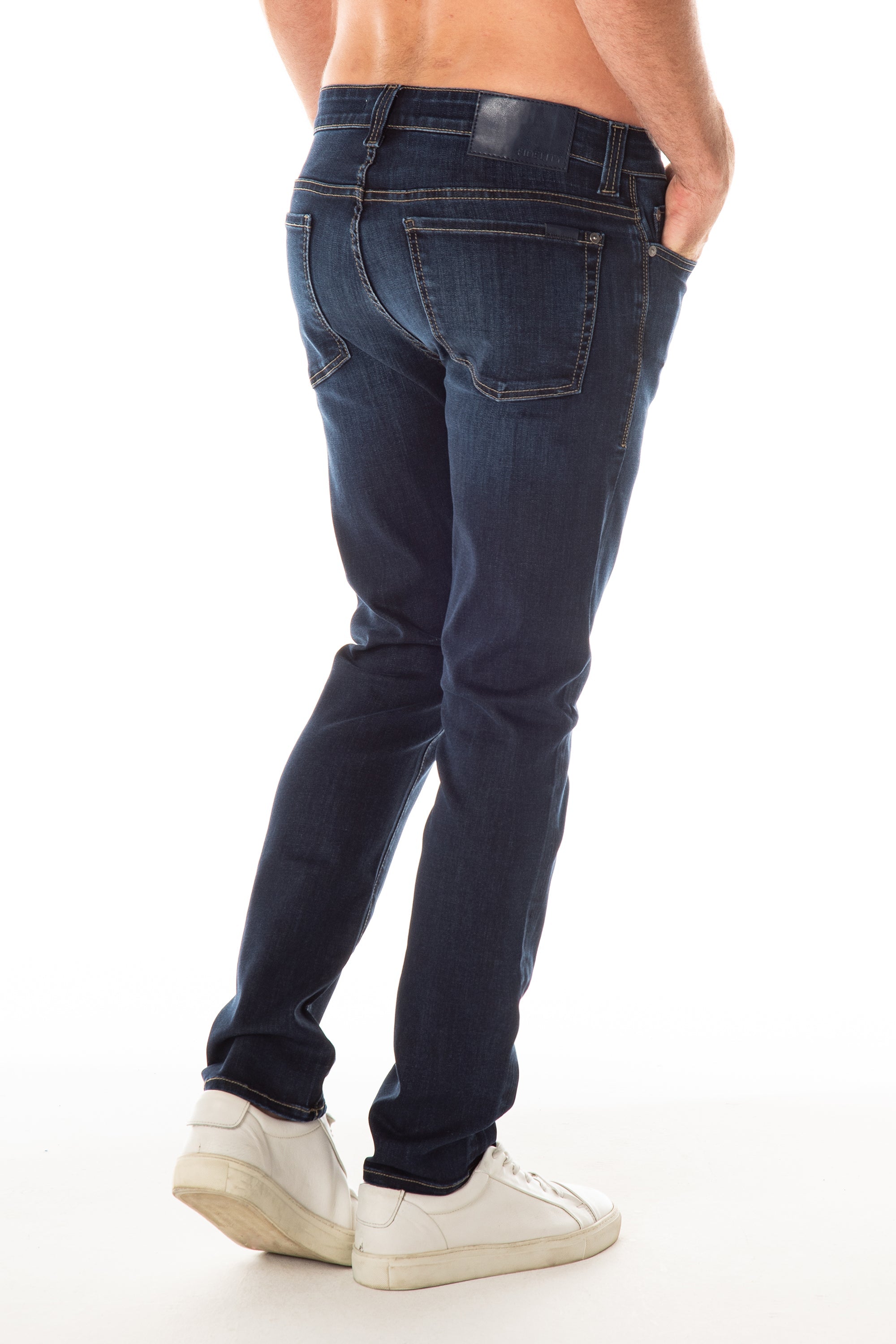 model wearing fidelity denim jimmy slim straight jean in empirical blue, shown from the rear