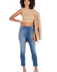 model wearing fidelity denim cher slim jean in st martin blue, paired with beige tank and blazer