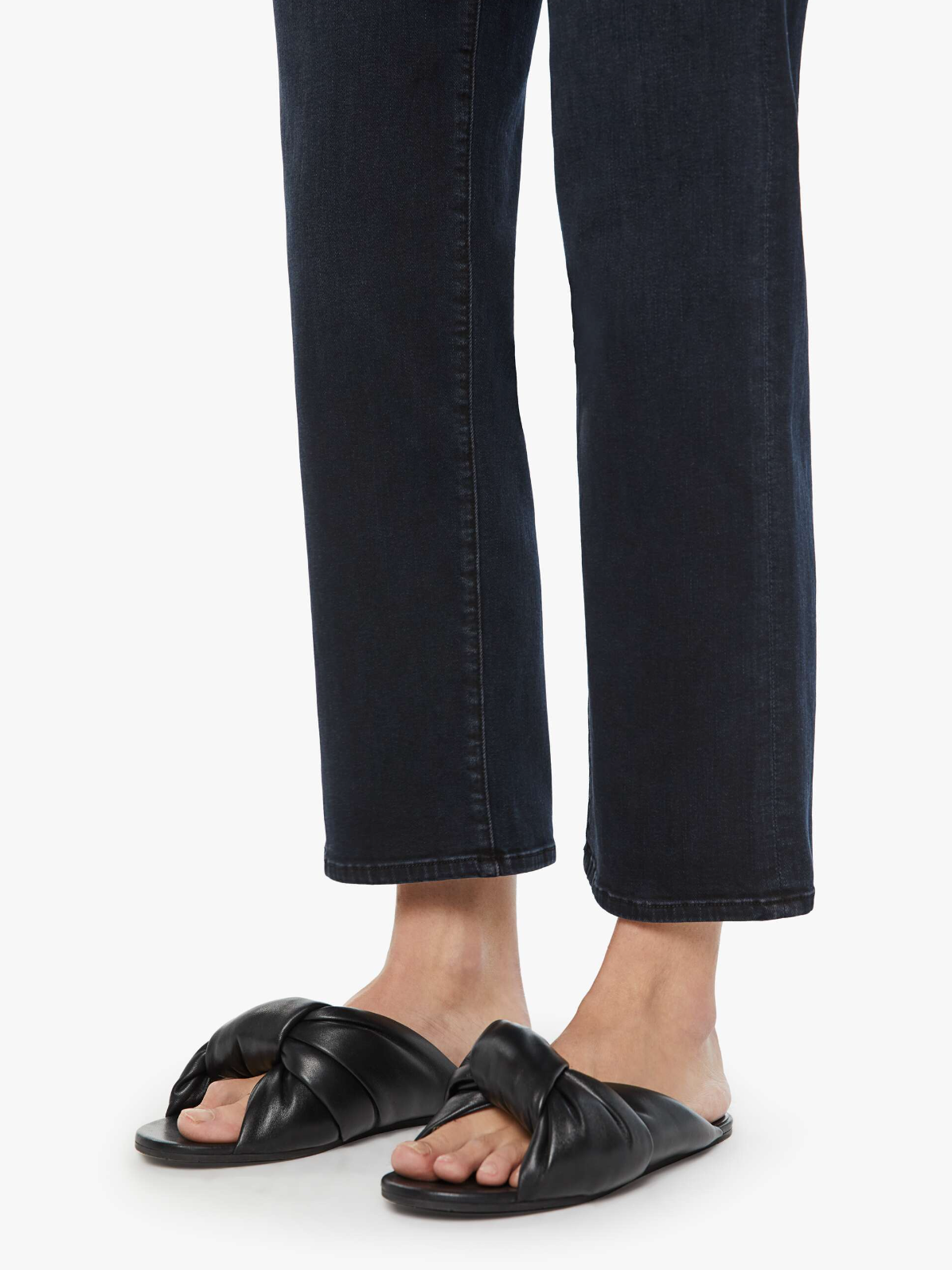 model wearing mother mid rise rambler zip ankle in night in venice, detail of hem