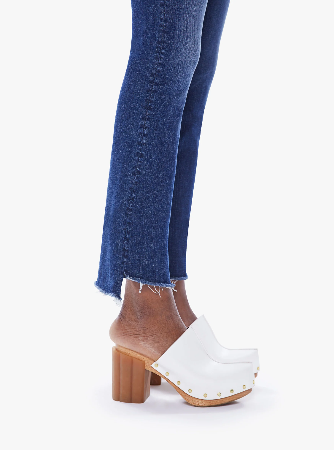 close up view of the hem of the insider crop step fray jean from Mother in teaming up blue