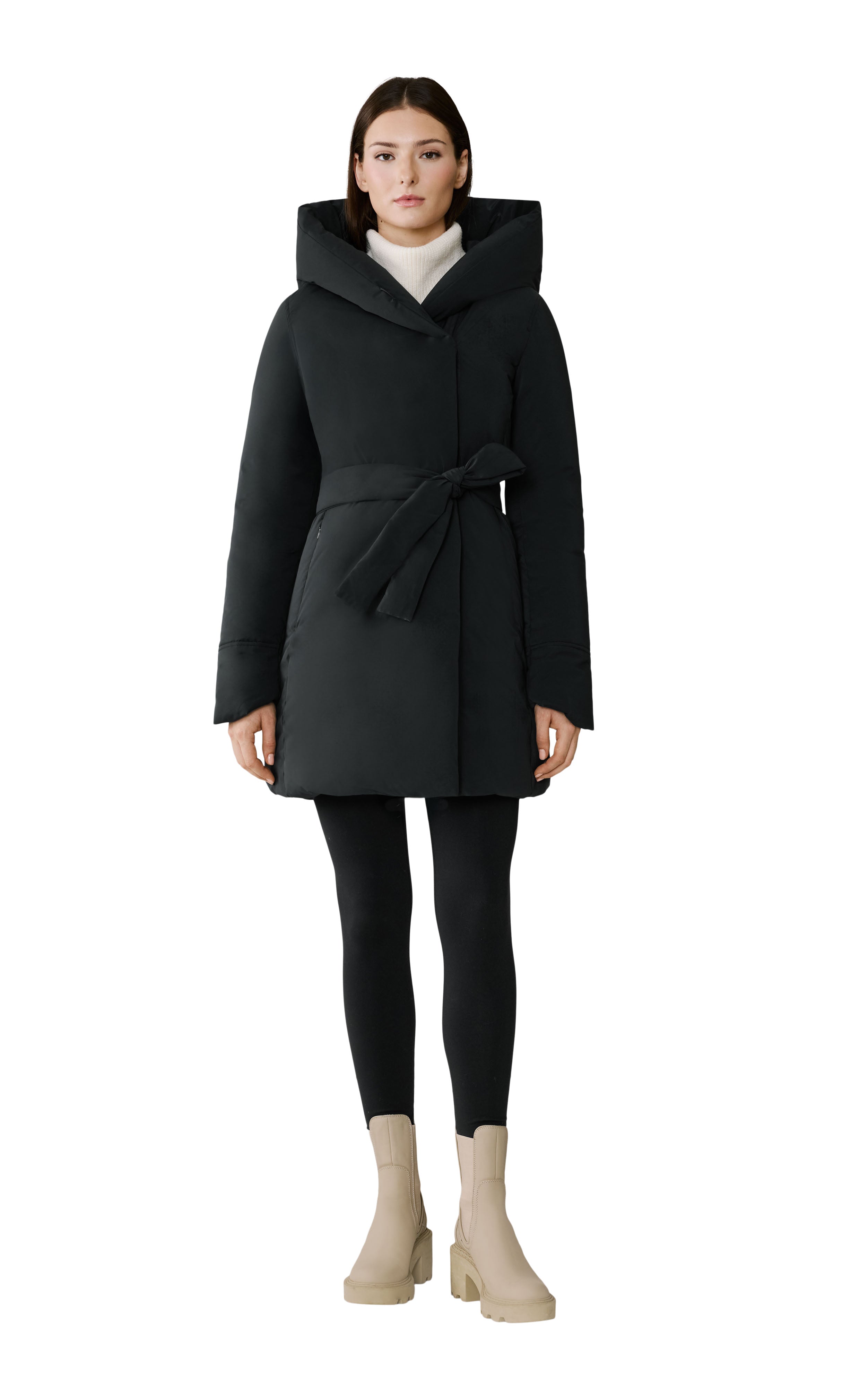 Woman wearing a black coat with a hood on a white background
