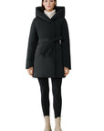 Woman wearing a black coat with a hood on a white background