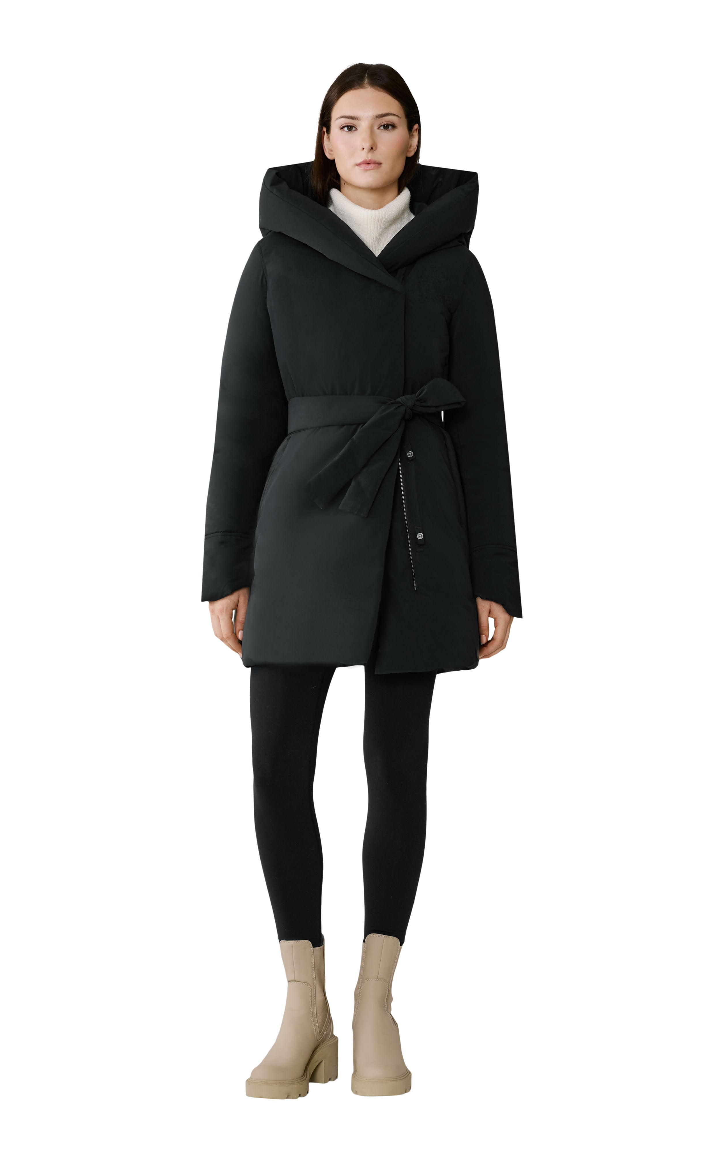 Woman wearing a black coat with a hood on a white background