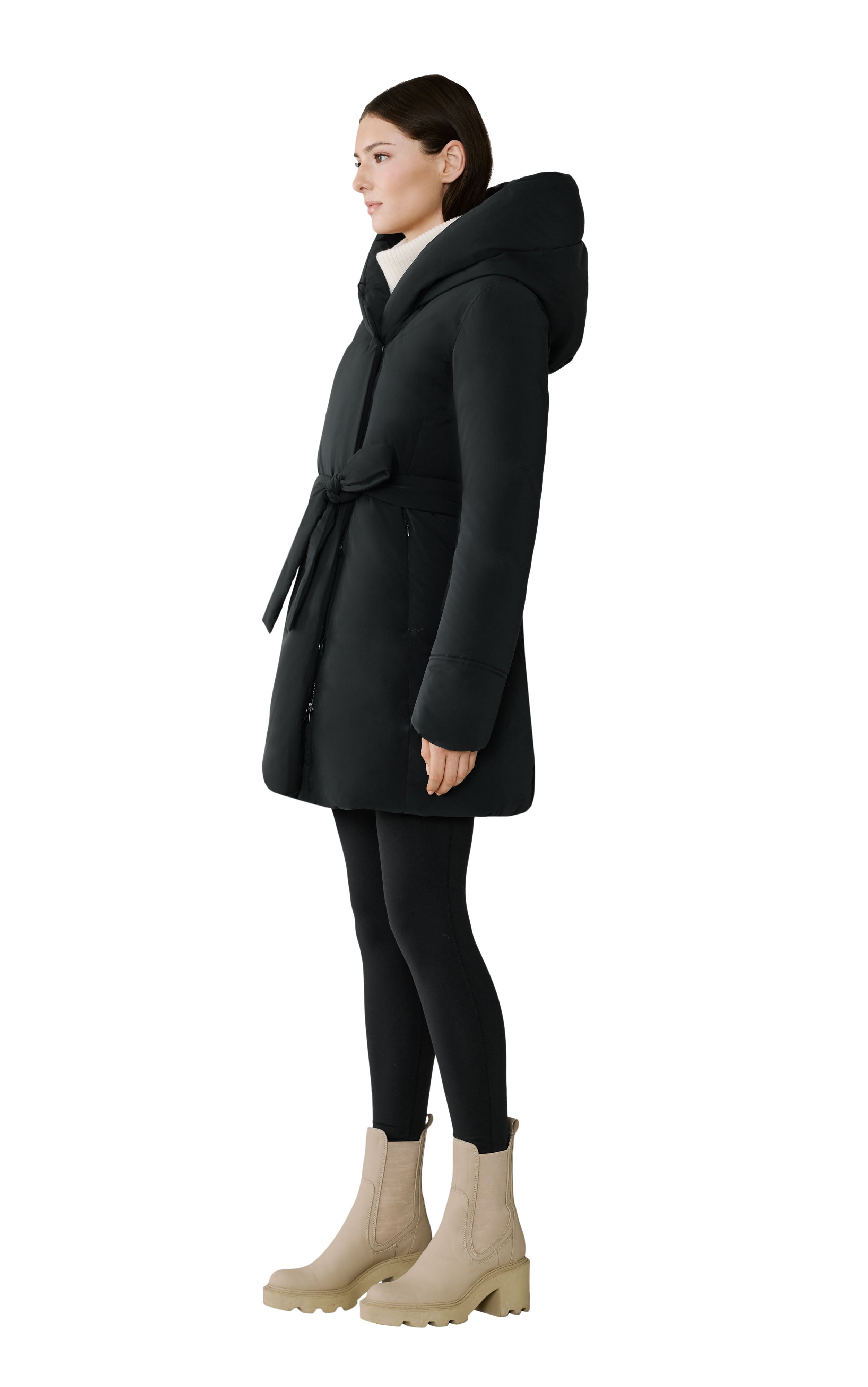 Woman wearing a black coat with a hood on a white background
