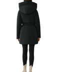 woman wearing a black coat with a hood on a white background