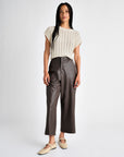 dark brown vegan leather ankle length wide leg trousers styled with a beige shirt