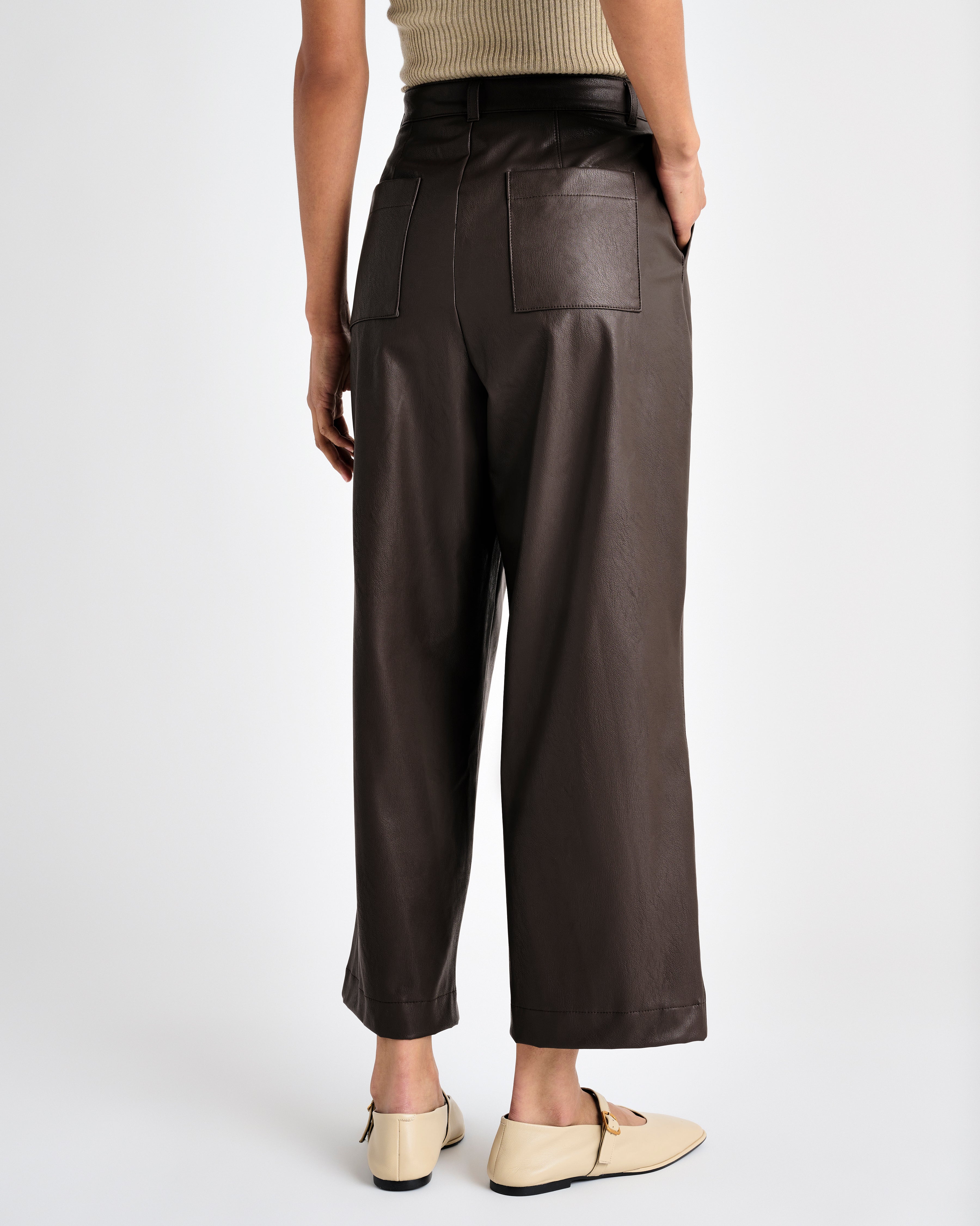 rear view of the dark brown vegan leather ankle length wide leg trousers