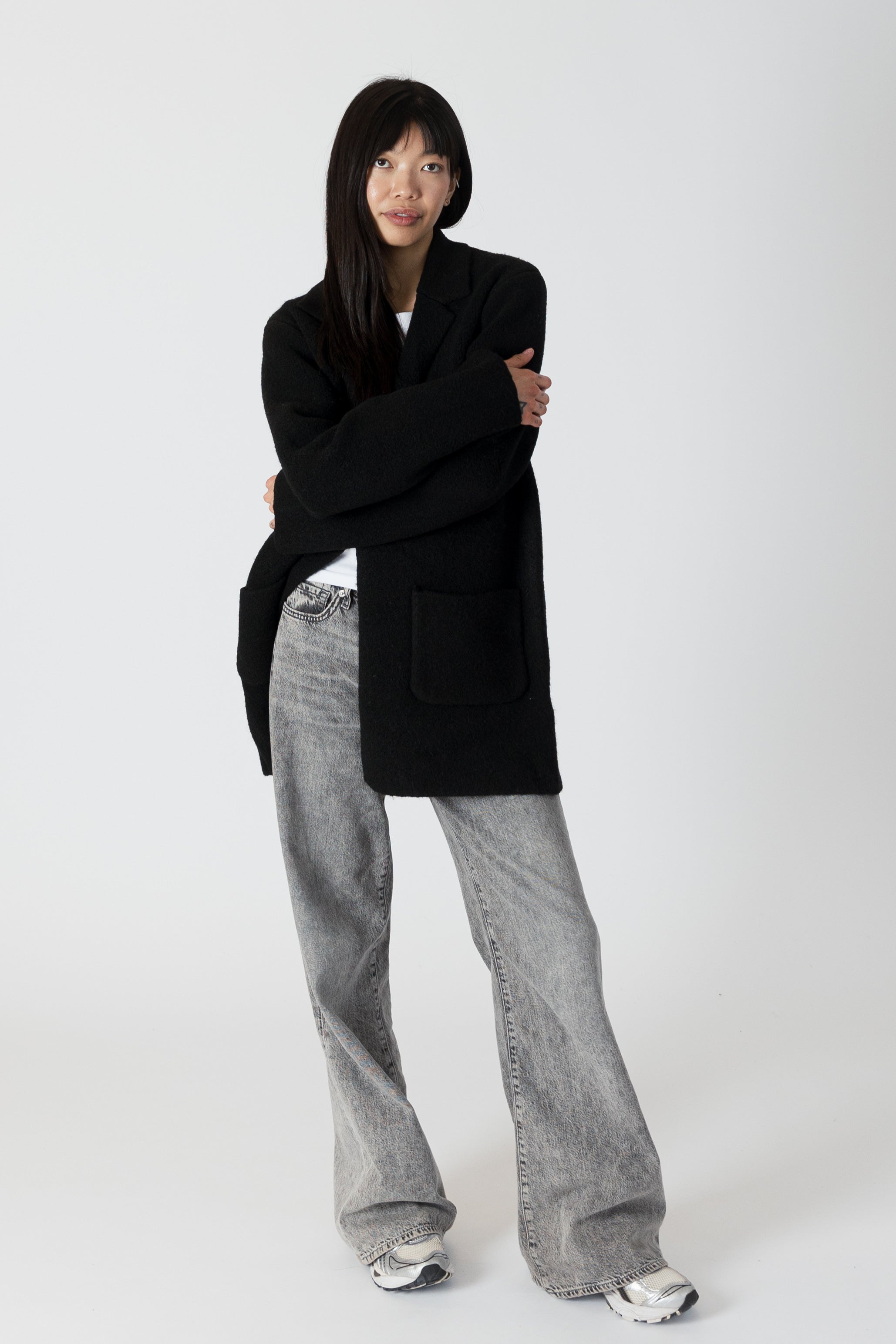 model wearing genie knit boyfriend blazer in black, posed