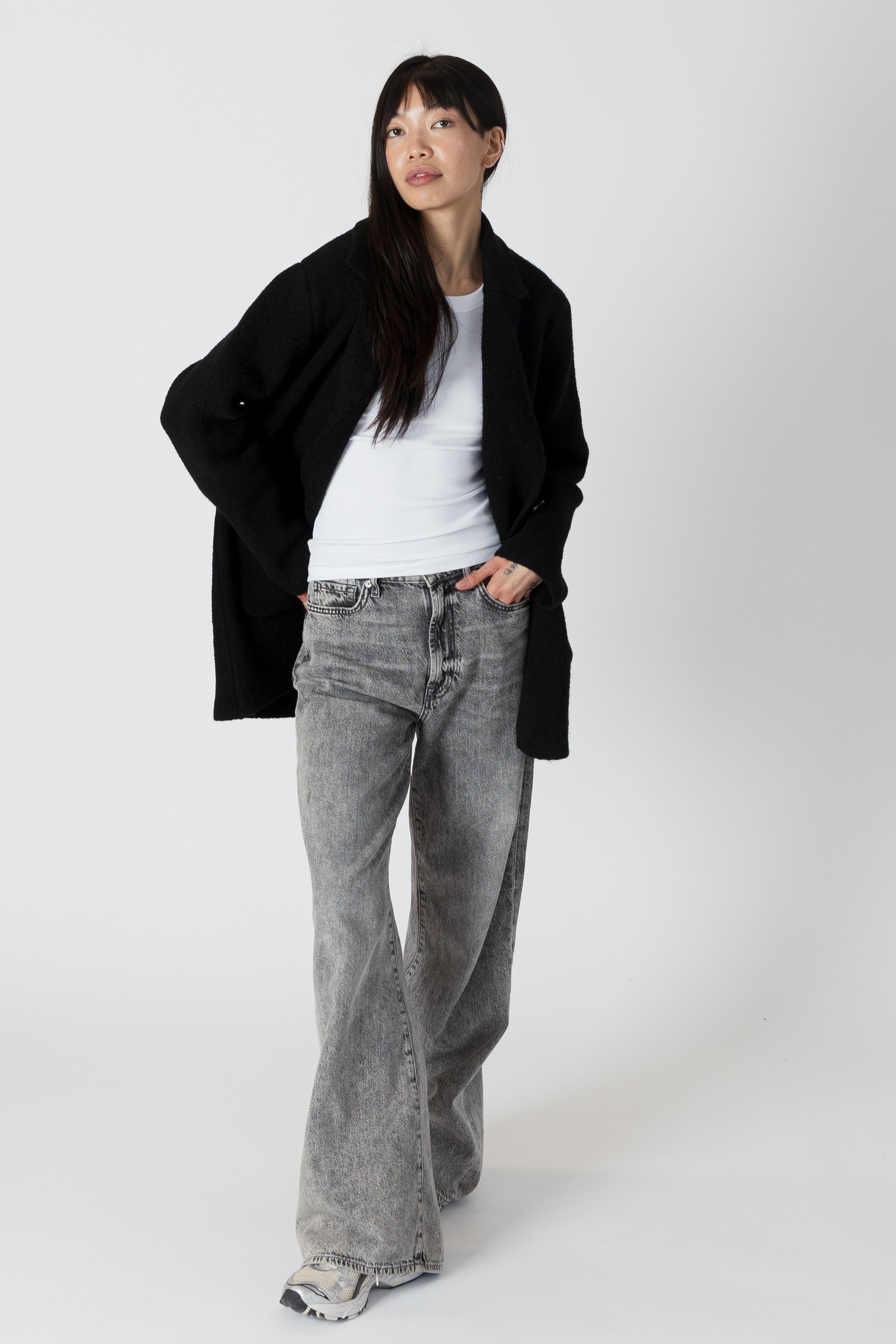 model wearing genie knit boyfriend blazer in black, unbuttoned, posed