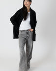 model wearing genie knit boyfriend blazer in black, unbuttoned, posed