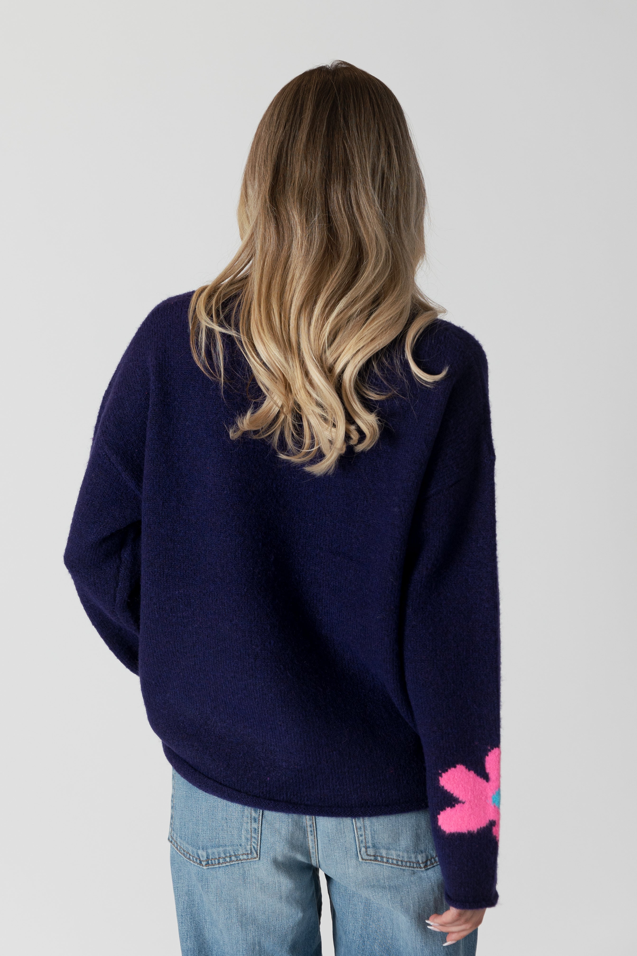 model wearing lyla & luxe jodi multicolour flower print sweater, rear view