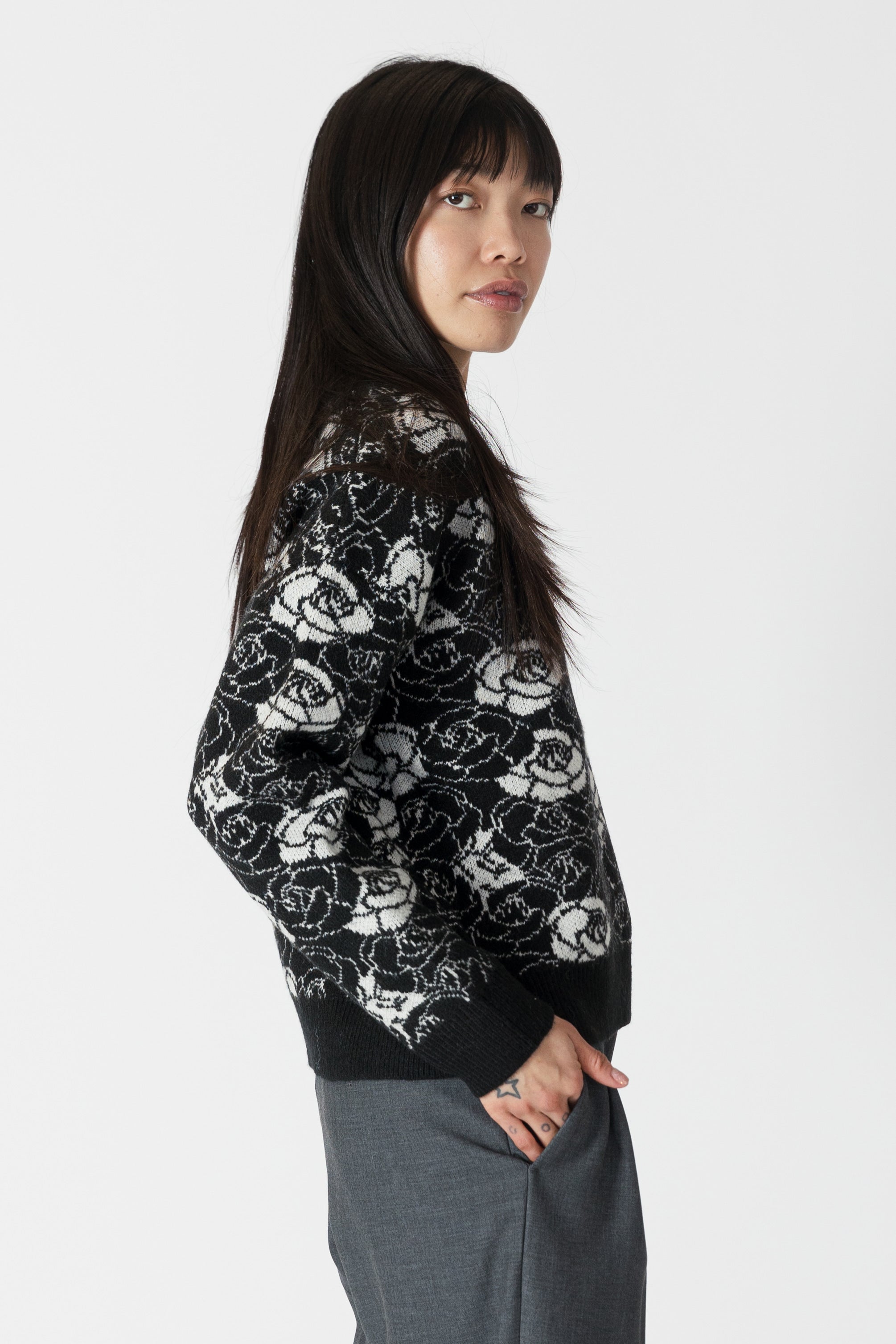 model wearing jordyn rose print crew neck sweater from lyla & luxe, side view