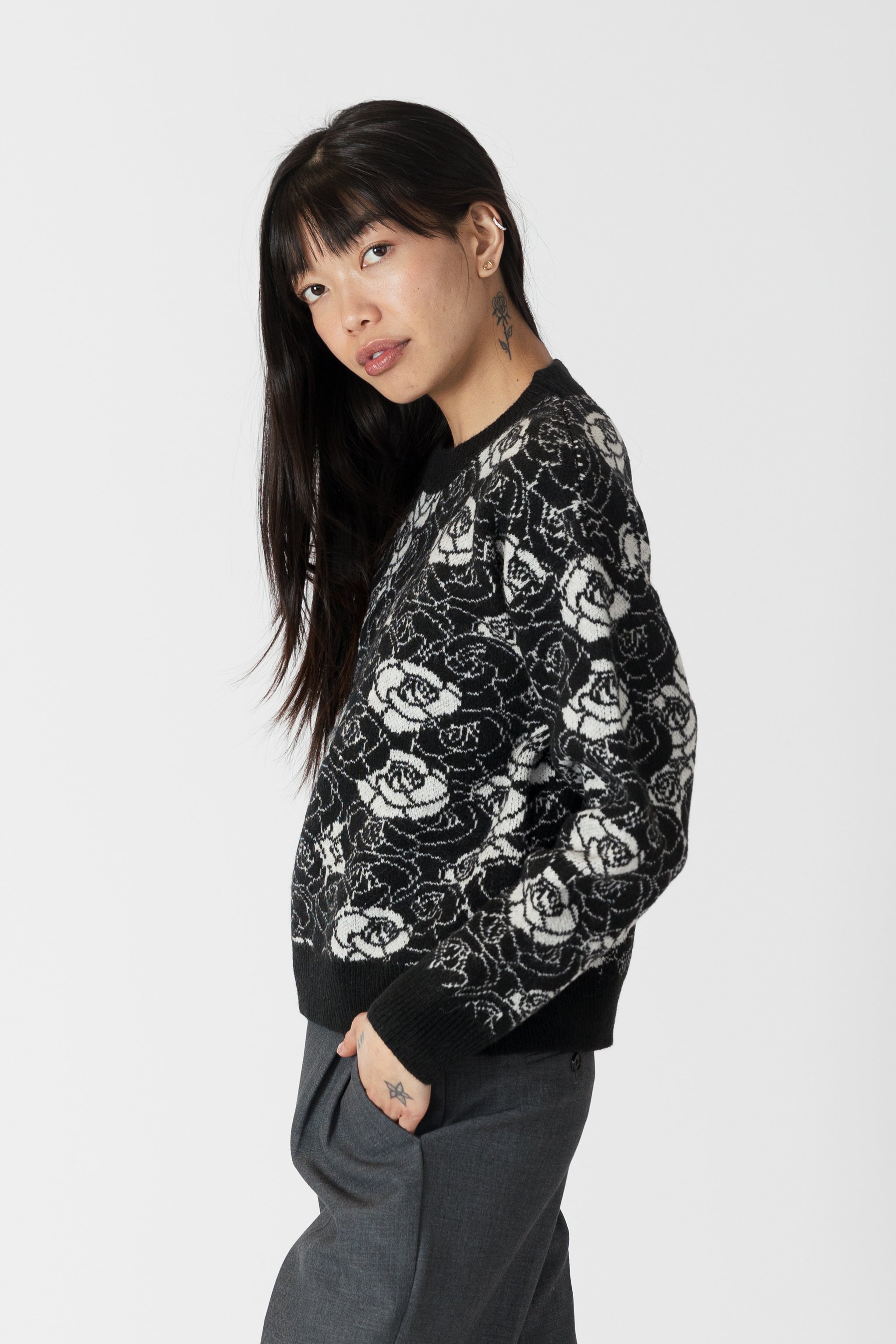model wearing jordyn rose print crew neck sweater from lyla & luxe, side view