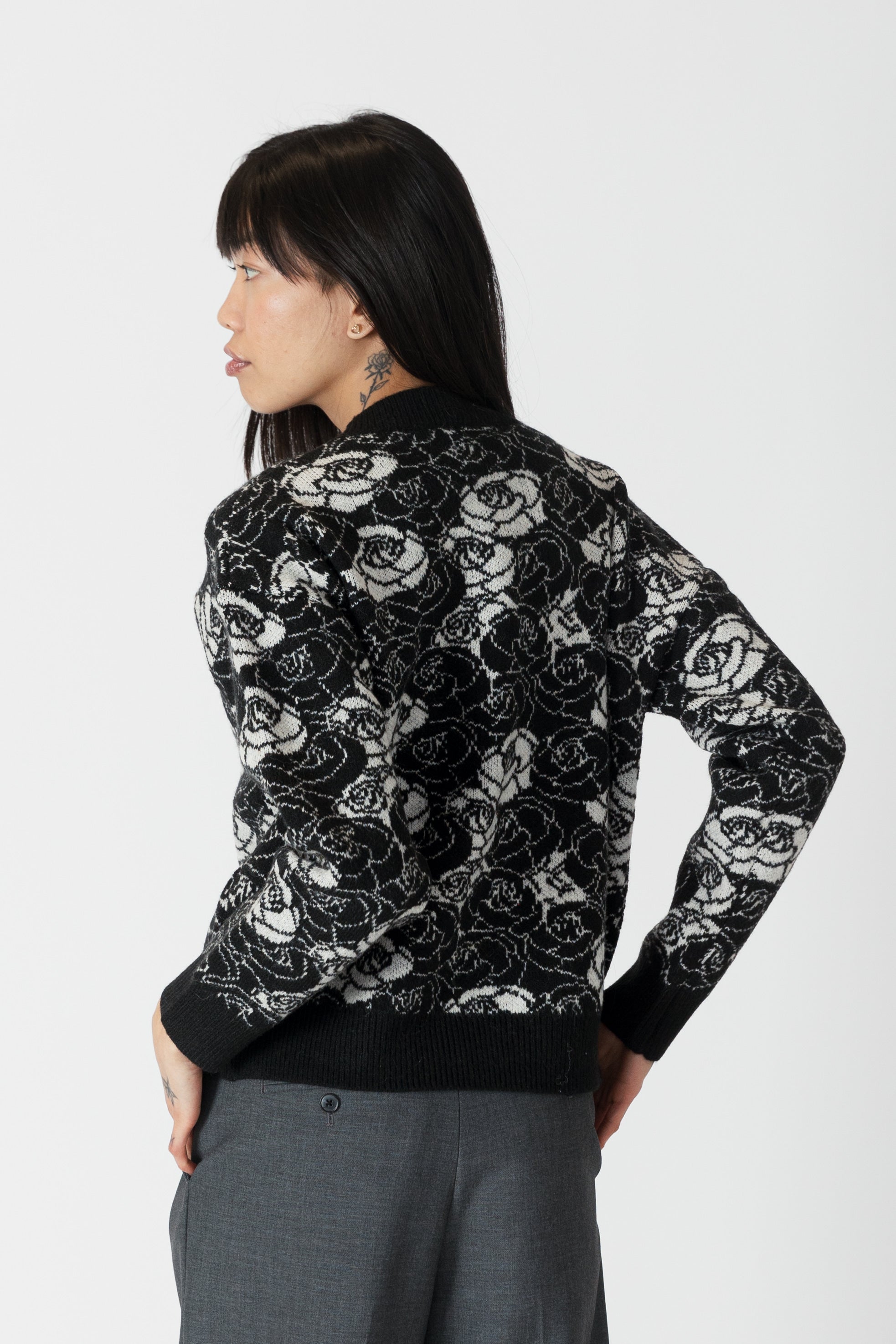 model wearing jordyn rose print crew neck sweater from lyla & luxe, rear view