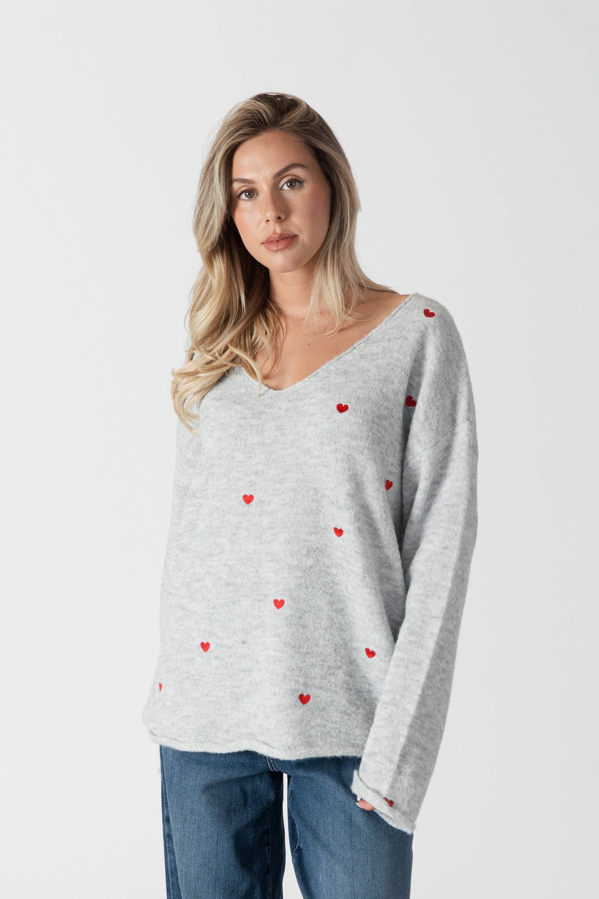model wearing lyla & luxe luna v-neck embroidered hearts sweater, front view