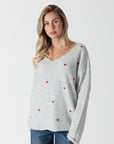 model wearing lyla & luxe luna v-neck embroidered hearts sweater, front view