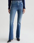 model wearing ag jeans farrah boot cut jean in montecito blue, shown from the waist down