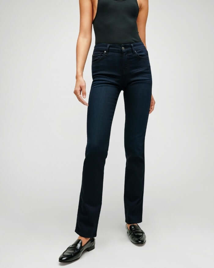 Model wearing 7 for all mankind&#39;s b(air) denim kimmie mid rise straight in blue black river thames, a dark blue wash 