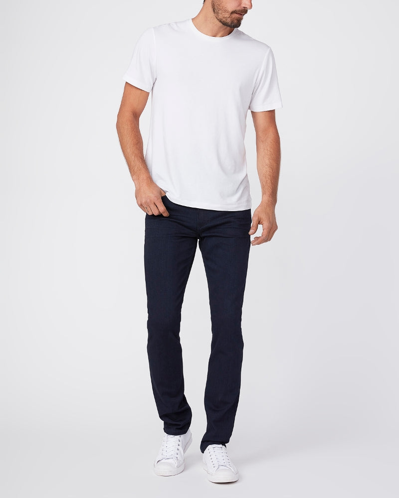 full body view of the lennox skinny fit jean from paige in inkwell dark blue, styled with a white t-shirt