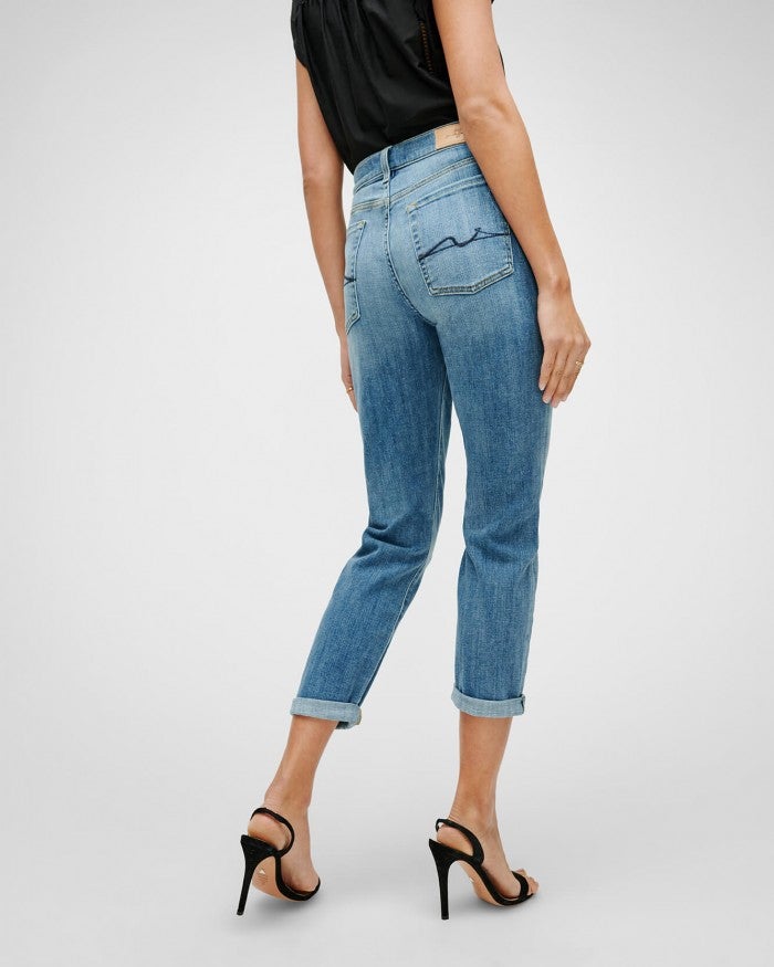 Model showing the rear view of 7 for all mankind luxe vintage josefina boyfriend jeans in a light blue wash
